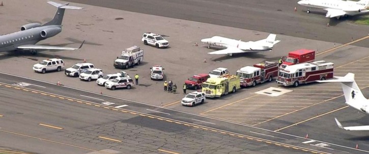 Emergency vehicles wait for a plane to attempt an emergency landing at Westfield-Barnes Regional Airport. 