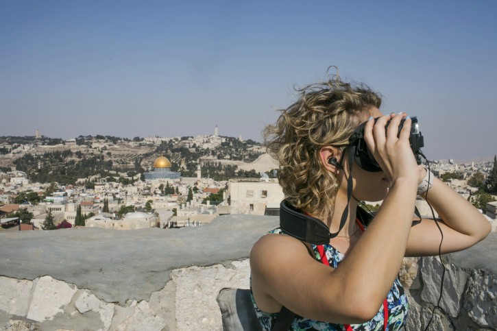 In this Monday, Sept. 3, 2018 photo, released by the Tower of David Museum, a visitor uses goggles on a new virtual reality tour that allows visitors to experience how archaeologists believe Jerusalem looked 2,000 years ago. The museum, which is housed in the Old City's ancient stronghold, plans to launch the high-tech guided tour in September ahead of the Jewish holiday of Sukkot. (Tomer Zmora, Tower of David Museum via AP)