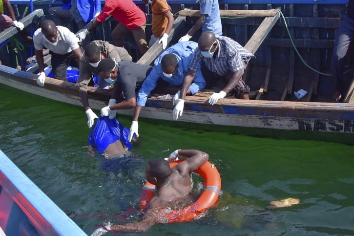 Rescuers retrieve a body from the water near Ukara Island in Lake Victoria, Tanzania Friday, Sept. 21, 2018. AP