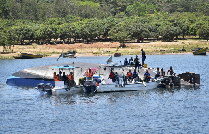 Rescue divers work alongside the capsized MV Nyerere passenger ferry on Ukara Island, Tanzania Saturday, Sept. 22, 2018. AP