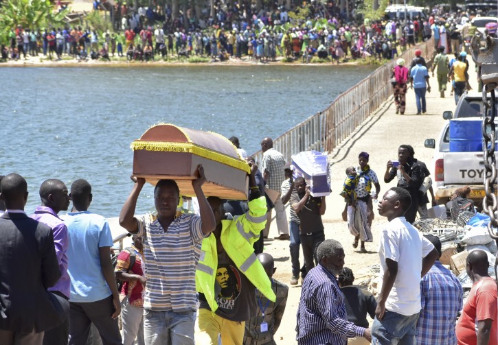 Relatives carry coffins to be used for the victims of the MV Nyerere passenger ferry on Ukara Island, Tanzania Saturday, Sept. 22, 2018. 