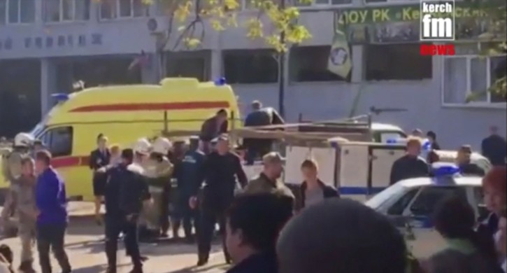 In this image made from video, showing the scene as emergency services load an injured person onto a truck, in Kerch, Crimea, Wednesday Oct. 17, 2018.  An explosive device has killed several people and injured at least 50 others at a vocational college in Crimea Wednesday in what Russian officials have called a possible terrorist attack. (Kerch FM News via AP) 