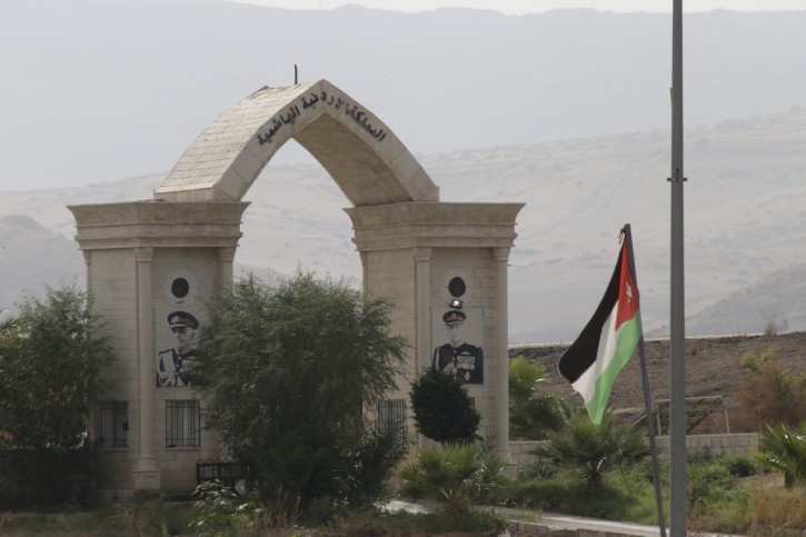 A Jordanian flag hangs on a pool on a bridge leading from Israel to Jordan in the Jordan valley area called Naharayim, or Baqura in Arabic, in northern Israel, Monday, Oct. 22, 2018. Jordan's King Abdullah II on Sunday said he has decided not to renew parts of his country's landmark peace treaty with Israel. (AP Photo/Ariel Schalit)
