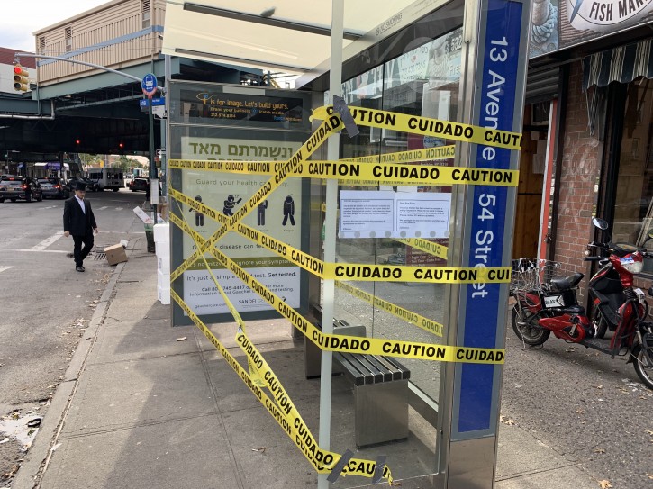 An advertisement on a bus shelter reading ‘Venishmartem Me'od Lenafshoseichem’ (to be careful with our lives) is seen taped off in Borough Park on Oct 16, 2018. About 1,400 bus shelters across NYC have been shut down for safety inspections after one collapsed earlier this month in Staten Island.