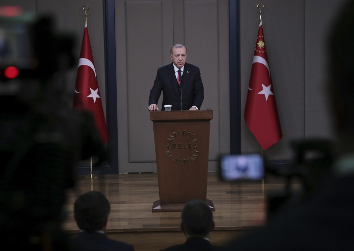 Turkey's President Recep Tayyip Erdogan talks to members of the media at the airport in Ankara, Turkey before departing to France, Saturday, Nov. 10, 2018. AP
