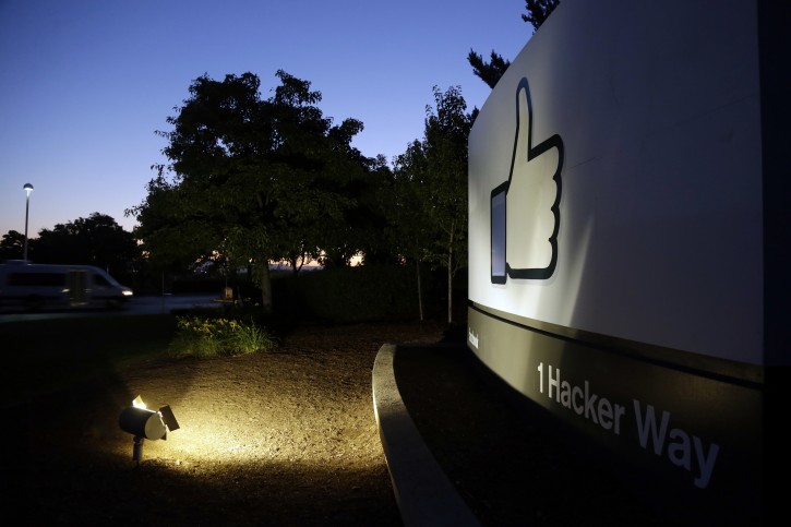 FILE- In this Jun 7, 2013, file photo, the Facebook "like" symbol is illuminated on a sign outside the company's headquarters in Menlo Park, Calif. Facebook says it is making progress on deleting hate speech, graphic violence and other violations of its rules, including detecting them before they are seen by users. The company released its second report Thursday, Nov. 15, 2018, detailing how it enforces community standards banning hate, nudity and other content. (AP Photo/Marcio Jose Sanchez, File)
