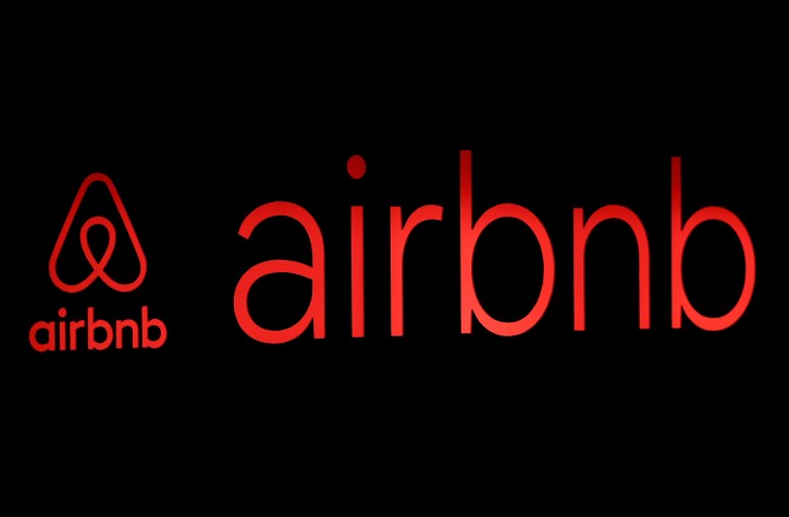 FILE - The logos of Airbnb are displayed at an Airbnb event in Tokyo, Japan, June 14, 2018. REUTERS/Issei Kato