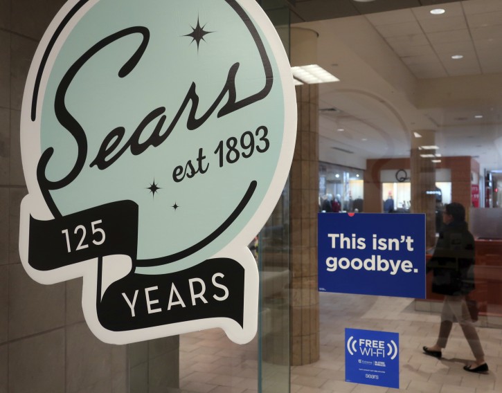 In this Nov. 2, 2018 photo, a sign in the window at Sears promises that "This isn't goodbye," at the Livingston Mall in Livingston, N.J. Sears is closing 80 more stores as it teeters on the brink of liquidation. The 130-year old retailer set a deadline of Friday, Dec. 28, 2018 for bids for its remaining stores to avert closing down completely. (AP Photo/Ted Shaffrey)