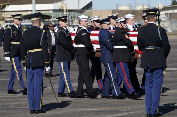 The flag-draped casket of former President George H.W. Bush is carried by a joint services military honor guard to Special Air Mission 41 at Ellington Field during a departure ceremony Monday, Dec. 3, 2018, in Houston. (AP Photo/David J. Phillip, Pool)