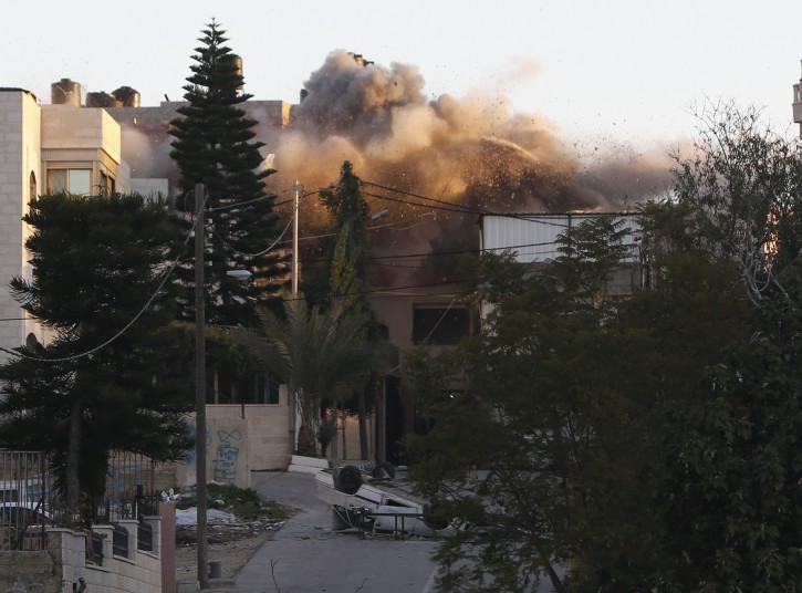 Israeli forces blow up Abu Humaid family house, in the West Bank city of Ramallah, Saturday, Dec. 15, 2018. Islalm Yousef Abu Humaid is accused of killing aIsraeli soldier by dropping a slab from a roof during a raid last May. (AP Photo/Majdi Mohammed)