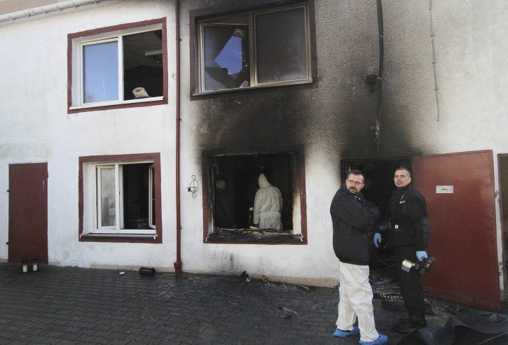 Forensic and other police experts examine the site of a fire in an Escape Room, in Koszalin, northern Poland, on Saturday, Jan. 5, 2019. Investigators in Poland on Saturday blamed a gas leak in a heating system at an "Escape Room" for a fire that killed five teenage girls and injured a man. (AP Photo)