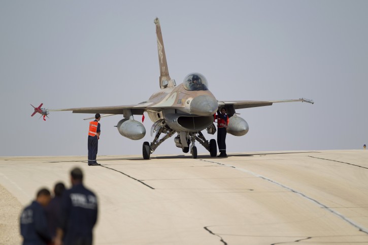 FILE - In this Nov. 25, 2013 file photo, Israeli air force technicians check an Israeli air force plane F-16 of the Red Dragon squadron at Ovda airbase near Eilat, southern Israel. (AP Photo/Ariel Schalit, file)