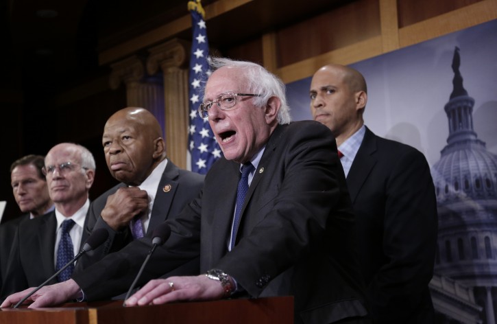 Sen. Bernie Sanders, I-Vt., center, joined from left by S en. Richard Blumenthal, D-Conn., Rep. Peter Welch, D-Vt., Rep. Elijah Cummings, D-Md., and Sen. Cory Booker, D-N.J., speaks to reporters as he prepares to introduce new legislation that aims to reduce what Americans pay for prescription drugs, especially  brand-name drugs deemed "excessively priced," during a news conference on Capitol Hill in Washington, Thursday, Jan. 10, 2019. (AP Photo/J. Scott Applewhite)