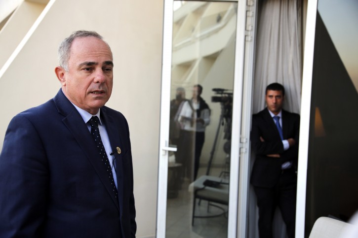 A bodyguard stands watching as Israel Energy minister Yuval Steinitz, speaks during an interview with the Associated Press in Cairo, Egypt, Monday, Jan. 14, 2019. Egypt has hosted its first ever regional gas forum, with several government delegations attending including the Israeli Energy Minister in the first such official visit since its 2011 Arab Spring uprising.(AP Photo/Amr Nabil)