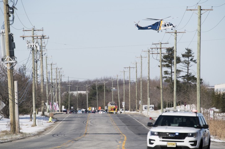 A New Jersey State Police helicopter prepares to land as officials respond to reports of an active shooter at a UPS facility Monday, Jan. 14, 2019 in Logan Township, N.J. (Joe Lamberti/Camden Courier-Post via AP)
