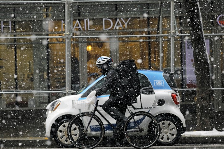 FILE - A man rides a bicycle in the snow during a late season snowstorm in New York, New York, USA, 21 March 2018. EPA