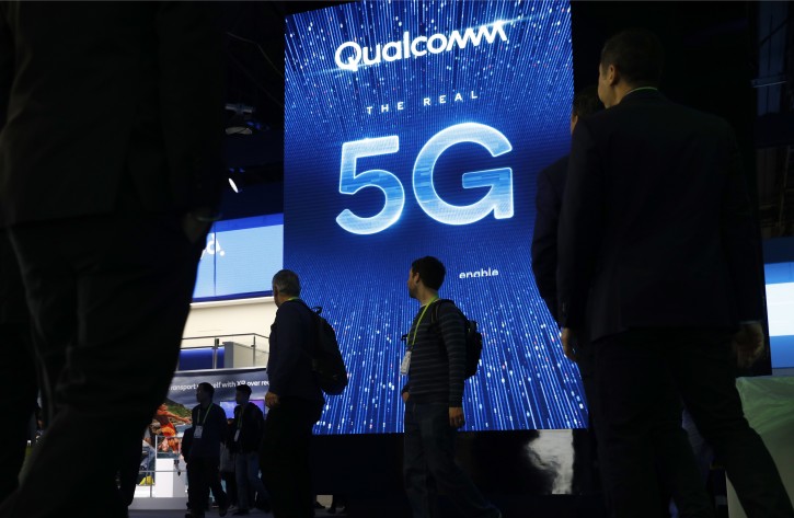 FILE - In this Jan. 9, 2019, file photo a sign advertises 5G at the Qualcomm booth at CES International in Las Vegas. 5G is a new technical standard for wireless networks that promises faster speeds; less lag, or 'latency,' when connecting to the network; and the ability to connect many devices to the internet without bogging it down. (AP Photo/John Locher, File)