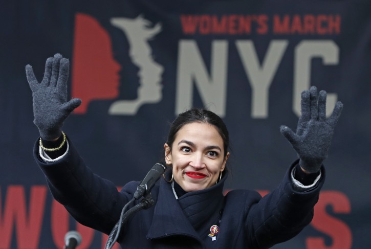 FILE - In this Jan. 19, 2019, file photo, U.S. Rep. Alexandria Ocasio-Cortez, D-New York, waves to the crowd after speaking at Women's Unity Rally organized by Women's March NYC at Foley Square in Lower Manhattan in New York. AP
