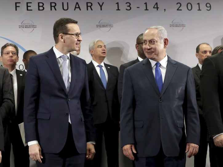 File -- In this Thursday, Feb. 14, 2019 photo Poland's Prime Minister Mateusz Morawiecki, left, and Israeli Prime Minister Benjamin Netanyahu, right, attend a group photo during a meeting in Warsaw, Poland. Poland's prime minister canceled plans for his country to send a delegation to meeting in Jerusalem on Monday after the acting Israeli foreign minister Israel Katz said that Poles "collaborated with the Nazis" and "sucked anti-Semitism from their mothers' milk". (AP Photo/Michael Sohn)