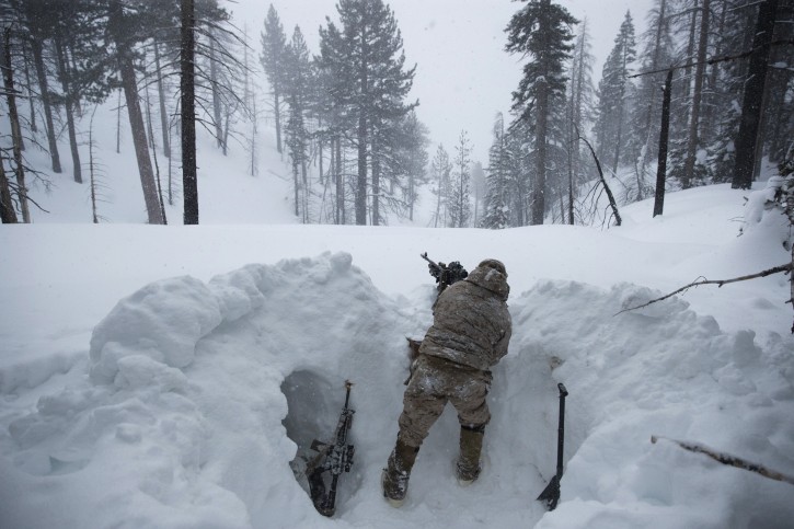 A U.S. Marine covers a machine gun in a trench while preparing for advanced cold-weather training at the Marine Corps Mountain Warfare Training Center Saturday, Feb. 9, 2019, in Bridgeport, Calif. After 17 years of war against Taliban and al-Qaida-linked insurgents, the military is shifting its focus to better prepare for great-power competition with Russia and China, and against unpredictable foes such as North Korea and Iran. (AP Photo/Jae C. Hong)