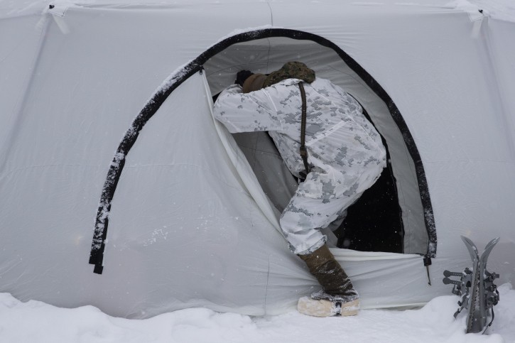 A U.S. Marine walks into a tent during advanced cold-weather training at the Marine Corps Mountain Warfare Training Center Saturday, Feb. 9, 2019, in Bridgeport, Calif. After 17 years of war against Taliban and al-Qaida-linked insurgents, the military is shifting its focus to better prepare for great-power competition with Russia and China, and against unpredictable foes such as North Korea and Iran. (AP Photo/Jae C. Hong)