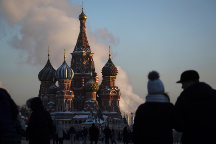 People walk in Red square during a cold day, with St. Basil's Cathedral in the background, in Moscow, Russia, Thursday, Jan. 24, 2019.  (AP Photo/Pavel Golovkin)