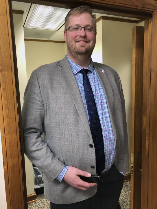North Dakota Insurance Commissioner Jon Godfread poses for a portrait at the state Capitol in Bismarck, North Dakota, Thursday, March 28, 2019. Godfread, who claims he is 6-foot11 3/4 inches, is challenging New York City councilman Robert Cornegy Jr., a 6-foot-10 councilman from Brooklyn's claim of being the tallest male politician in the world. Comegy was  certified by Guinness World Records in January. But wait, Brad Sellers, a former Ohio State and Chicago Bulls star listed at 7 feet, also says he has a claim. Sellers is now the mayor of Warrensville Heights, Ohio. (AP Photo/James MacPherson).
