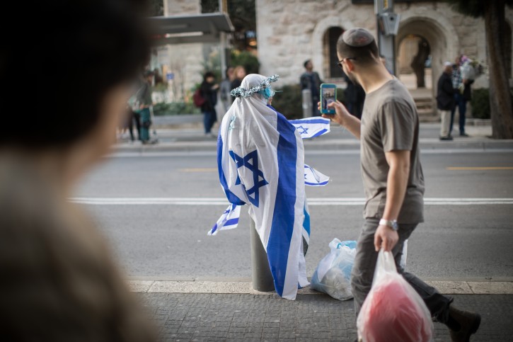 A woman dressed in Israeli flags demonstrates on King George street in central Jerusalem on March 13, 2019. Photo by Hadas Parush/Flash90 