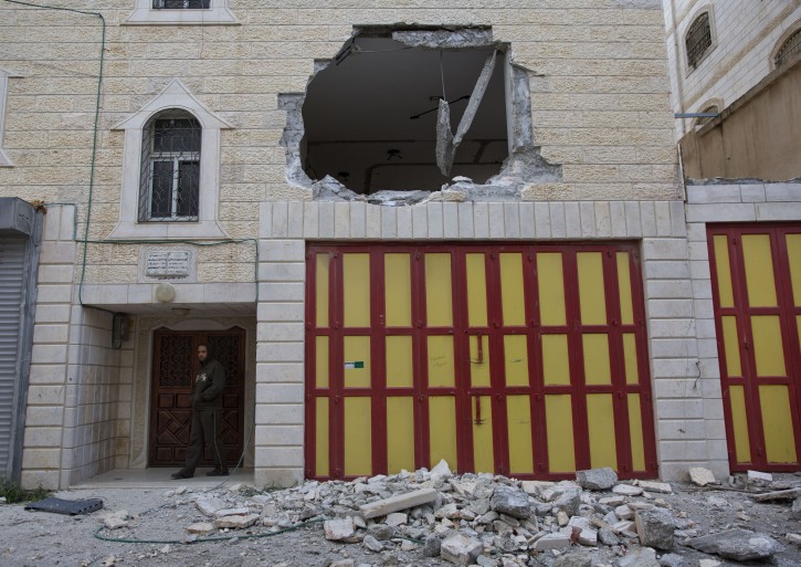 A hole is seen in one of the two apartments belonging to the father of Arafat Erfayieh, that was demolished by Israeli forces in the West Bank city of Hebron, Friday, April 19, 2019. The Israeli military has demolished the family home of Erfayieh, a Palestinian charged with the killing of a 19-year-old Israeli woman. (AP Photo/Nasser Nasser)