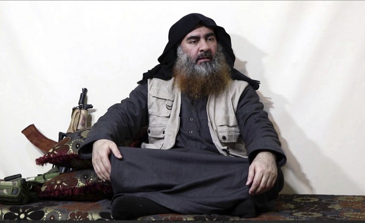 FILE - This file image made from video posted on a militant website Monday, April 29, 2019, purports to show the leader of the Islamic State group, Abu Bakr al-Baghdadi, being interviewed by his group's Al-Furqan media outlet.  (Al-Furqan media via AP, File)