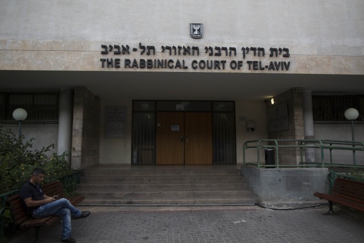 FILE - A man sits outside the Rabbinical Court in Tel Aviv on November 27, 2013. Photo by Yonatan Sindel/Flash90 