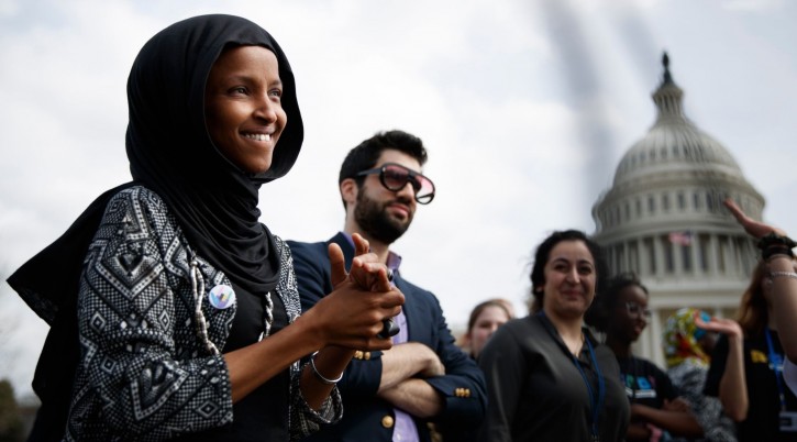 Rep. Ilhan Omar, along with her spokesman, Jeremy Slevin, attend a youth protest at the Capitol trying to force action on climate change, March 15, 2019. (Tom Brenner/Getty Images)