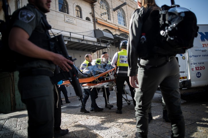 Israeli security forces and medics remove the body of a Palestinian man who had stabbed two Israelis in the Old City of Jerusalem, on May 31, 2019. FLash90