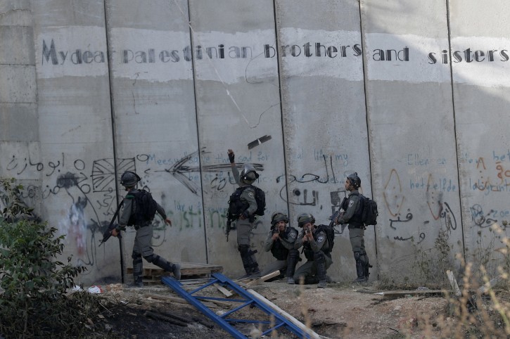 Israeli border police remove a tools used by  young Palestinians to climb over an Israeli barrier at A-Ram town north of Jerusalem, Israel, 31 May 2019.EPA