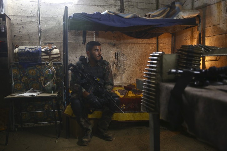 In this Thursday, May 30, 2019 photo, an actor waits for his scene on the set of Israel's hit TV show "Fauda," in Tel Aviv, Israel. After two successful seasons, co-creators Avi Issacharoff and Lior Raz are hard at work on their much-anticipated third season, a good portion of which takes place in the Gaza Strip. The season debut date for the Netflix hit hasn't been revealed, but the trailer is being released this week. (AP Photo/Oded Balilty)
