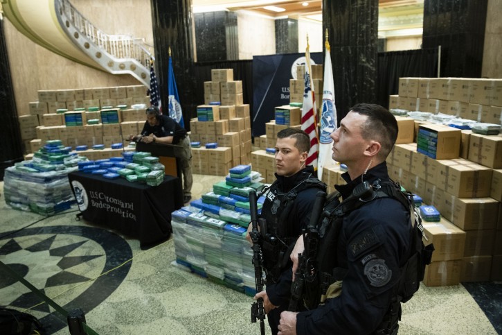 Officers stand guard over a fraction of the cocaine sized from a ship at a Philadelphia port is seen ahead of a news conference at the U.S. Custom House in Philadelphia, Friday, June 21, 2019. Federal officials have estimated the seized drugs had a street value of more than $1 billion. (AP Photo/Matt Rourke)
