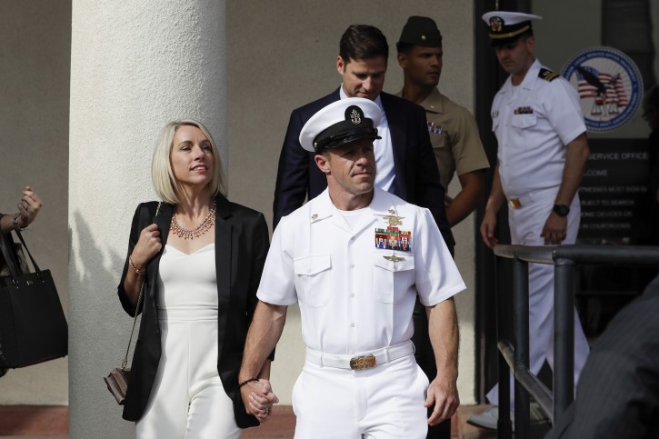 Navy Special Operations Chief Edward Gallagher, center, walks with his wife, Andrea Gallagher, as they leave a military court on Naval Base San Diego, Tuesday, July 2, 2019, in San Diego. (AP Photo/Gregory Bull)