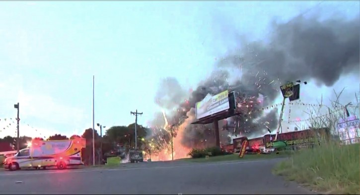 This still image taken from video provided by WCNC shows containers of fireworks exploding at the Davey Jones Fireworks and the House of Fireworks stores in Fort Mill, S.C., on Thursday, July 4, 2019.  AP