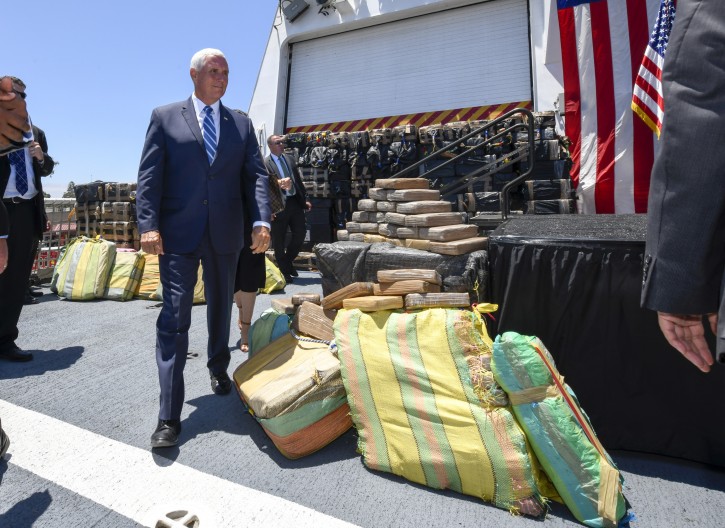 Vice President Mike Pence walks past bales of seized cocaine during a visit to the U.S. Coast Guard Cutter Munro, Thursday, July 11, 2019, in Coronado, Calif. (AP Photo/Denis Poroy)