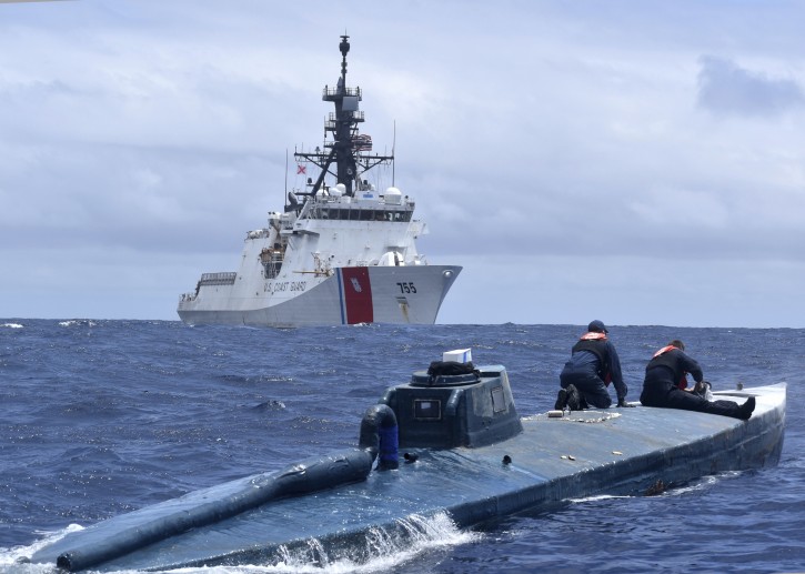 This June 19, 2019 photo provided by the U.S. Coast Guard shows U.S. Coast Guard Cutter Munro (WMSL 755) crew members inspecting a self-propelled semi-submersible in international waters of the Eastern Pacific Ocean. Coast Guard crews seized more than 39,000 pounds of cocaine and 933 pounds of marijuana, worth a combined estimated $569 million, through 14 separate suspected drug smuggling interdictions and disruptions off the coasts of Mexico, Central and South America by three Coast Guard cutters between May and July 2019. (Petty Officer 1st Class Matthew Masaschi/U.S. Coast Guard via AP)