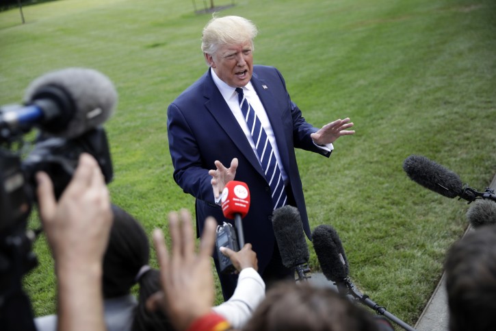 President Donald Trump speaks to members of the media before boarding Marine One helicopter on the South Lawn of the White House in Washington, for the short flight to nearby Andrews Air Force Base, Md., Friday, July 19, 2019. (AP Photo/Pablo Martinez Monsivais)