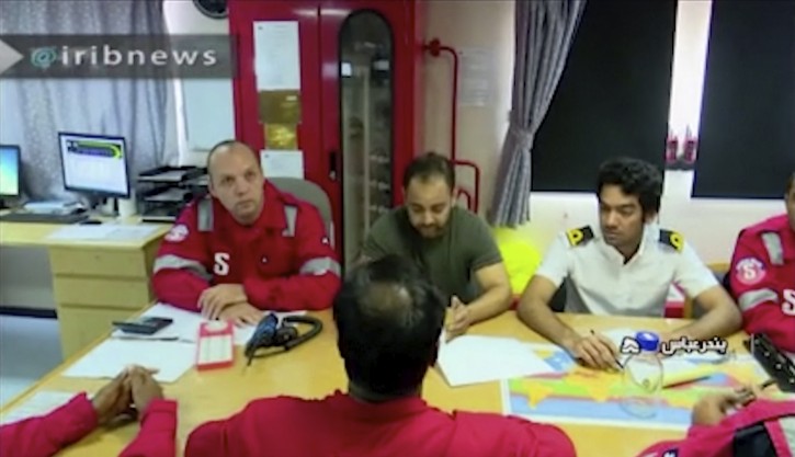 In this photo released by state-run IRIB News Agency, which aired on Monday, July 22, 2019, shows various crew members of the British-flagged tanker Stena Impero, that was seized by Tehran in the Strait of Hormuz on Friday, during a meeting.  (IRIB News Agency via AP)