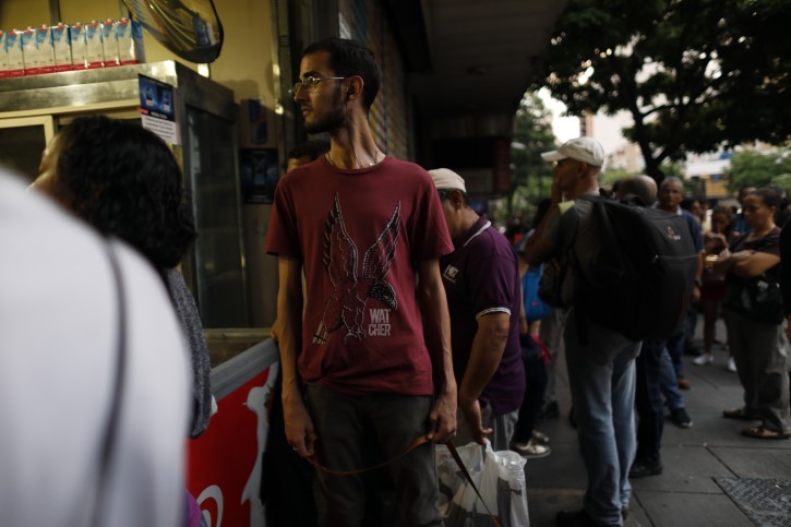 People walk in the streets of Caracas after a massive blackout left the city and other parts of the country without electricity, in Caracas Venezuela, Monday, July 22, 2019. The power in the capital went out around 4:30 p.m. (2030 GMT) and immediately backed up traffic as the subway stopped working and office workers had to begin trekking home during rush hour. (AP Photo/Ariana Cubillos)