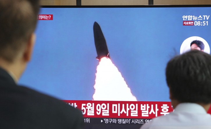 People watch a TV showing a file image of North Korea's missile launch during a news program at the Seoul Railway Station in Seoul, South Korea, Thursday, July 25, 2019. North Korea fired two unidentified projectiles into the sea on Thursday, South Korea's military said, the first launches in more than two months as North Korean and U.S. officials work to restart nuclear diplomacy. The signs read: "North Korea fired after May 9." (AP Photo/Ahn Young-joon)