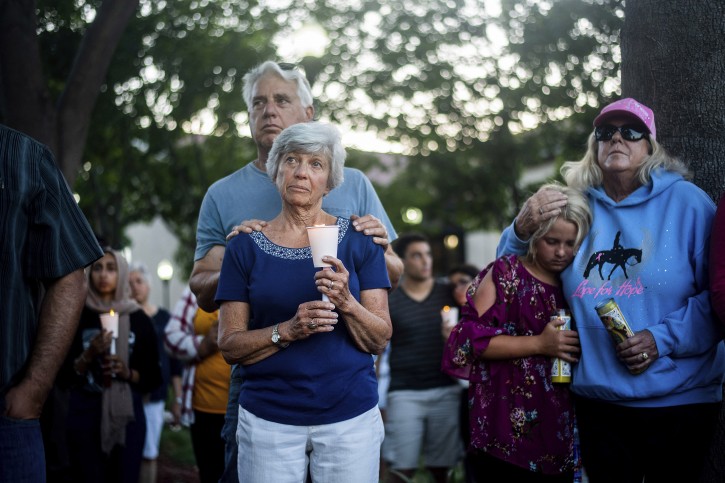 Susan Meyers and husband Michael Oshan listen to a hymn during a vigil for victims of a Sunday evening shooting that left three people dead at the Gilroy Garlic Festival on Monday, July 29, 2019, in Gilroy, Calif. (AP)